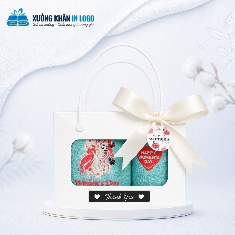 Set 2 khăn quà tặng thêu logo Cotton SKB-17 màu xanh ngọc thêu họa tiết Womens Day đặt trong hộp quai xách thắt nơ trắng sữa nhã nhặn.